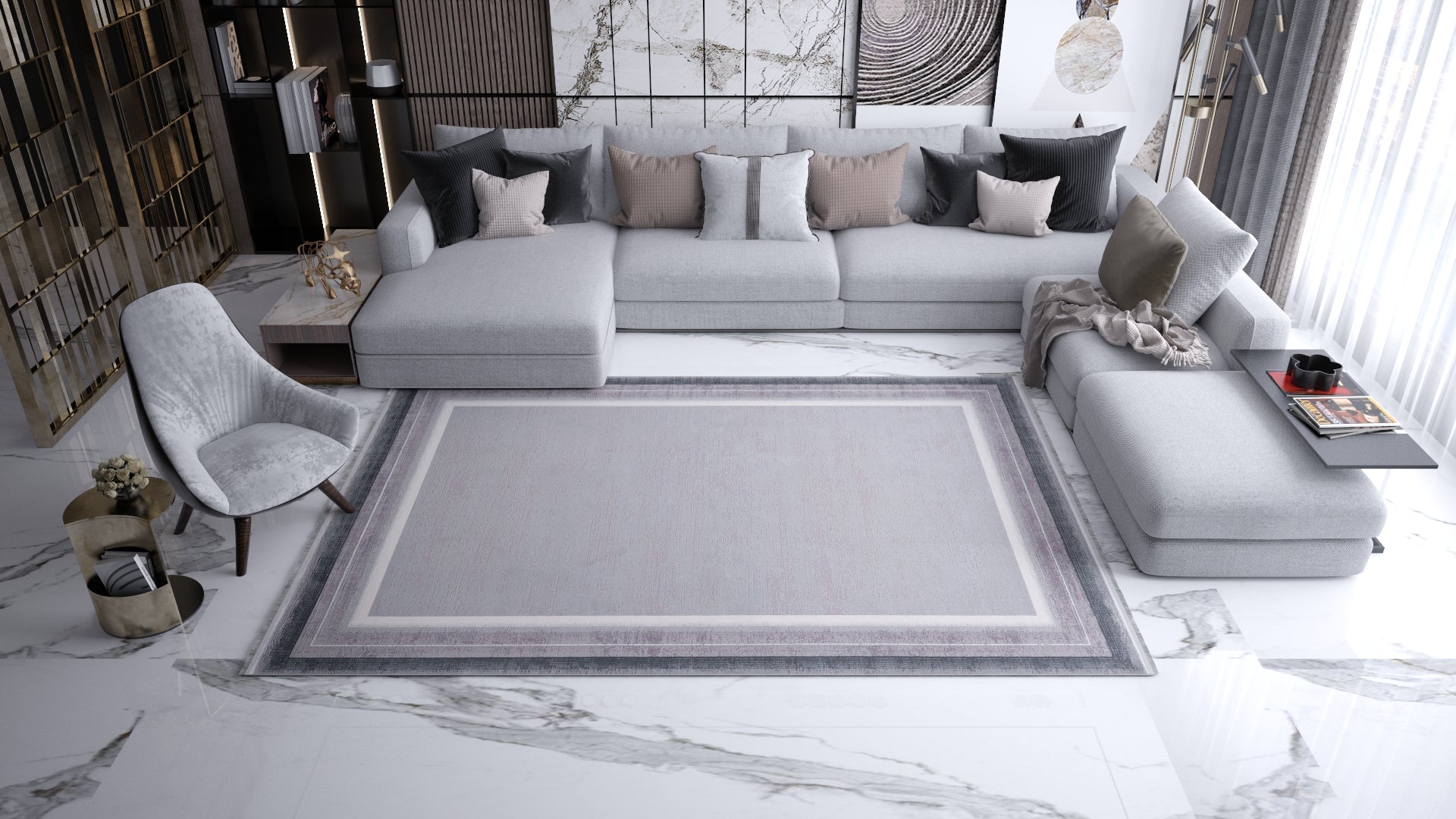 A modern living room with a large gray sectional, neutral-toned pillows, a gray armchair, bookshelves, abstract wall art, and the Radiant Edges Bordered Rug - Silver - M542B on a white marble floor. Sunlight filters through sheer curtains.