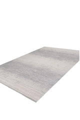 The Radient Silver Haze Ombre Rug - M497D is a rectangular, machine-made flat pile rug featuring a minimalist gradient design in light gray and off-white, shown laid flat on a white background.