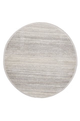 The Radient Silver Haze Ombre Rug - M497D is a minimalist, round machine-made rug in light gray and beige with a subtle textured pattern and a simple border around the edge.