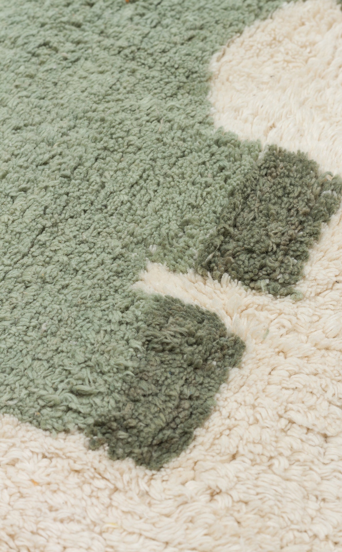Close-up of the Rainbow Nap - Washable Shaggy - CBN08 rug, featuring light green, dark green, and cream patterns. Its soft, textured fibers make it a cozy and practical choice for kids' playrooms.