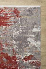 The Red Strokes Premium Rug - 1052EB features modern abstract designs in red, gray, white, and orange on high-quality acrylic-viscose. It rests on a light wood floor with a short white fringe along the upper edge.