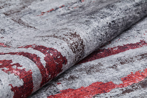 Load image 1 in gallery view. A close-up of the Refined and Timeless - Washable Rug - JR1500 (Custom Size) highlights its abstract gray, red, and dark brown pattern with a fold that showcases fabric texture—perfect for high-traffic areas.