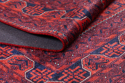 Load image 1 in gallery view. A close-up of the Regal Accents - Washable Rug - JR36 (Custom Size) shows its red and dark blue geometric patterns and intricate borders. The durable weave highlights fine craftsmanship, making it ideal for busy spaces.