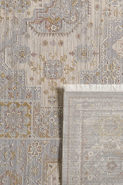 Load image 1 in gallery view. A close-up of the Revived Legacy Premium Rug - M616M shows its textured, patterned surface in muted grey, beige, and gold. The folded lower right corner reveals the intricate design on both sides of this stylish viscose polyester rug.