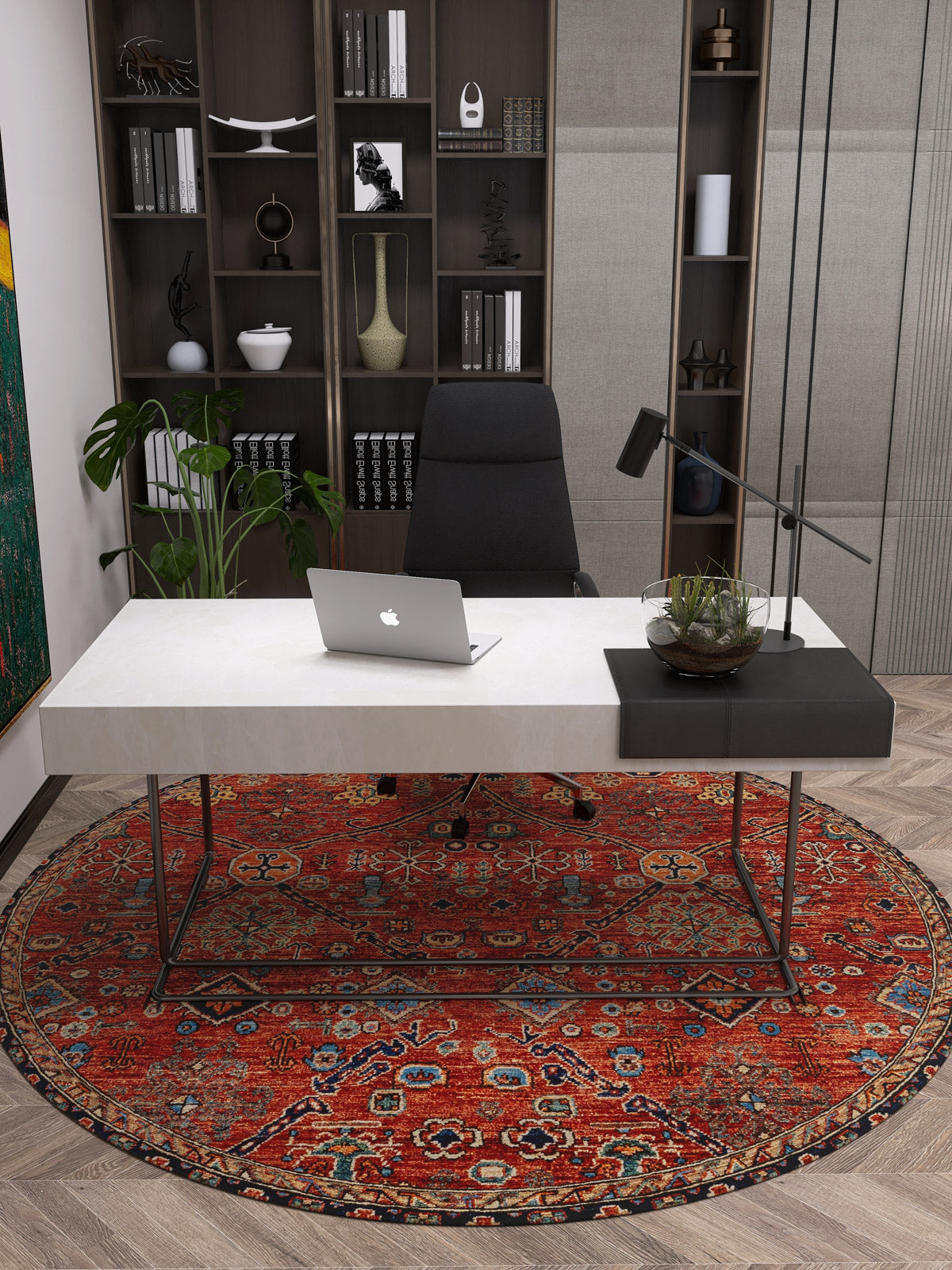 Modern office with a white desk, laptop, and black chair on the Rhapsody Authentic Red Washable Rug - LCC3033 (Custom Size), perfect for high-traffic areas. Bookshelves with decor and books are behind, with a green plant to the left of the desk.