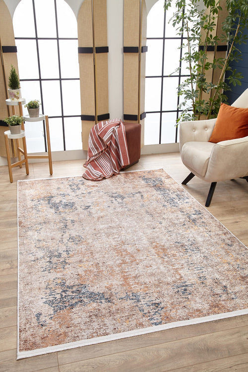 Load image 1 in gallery view. A modern living room featuring the Rhythmic Ripples - Washable Rug - JR1637 (Custom Size) in cream and beige, a beige armchair with an orange pillow, a brown ottoman with a striped blanket, a plant, and large windows bright with natural light.