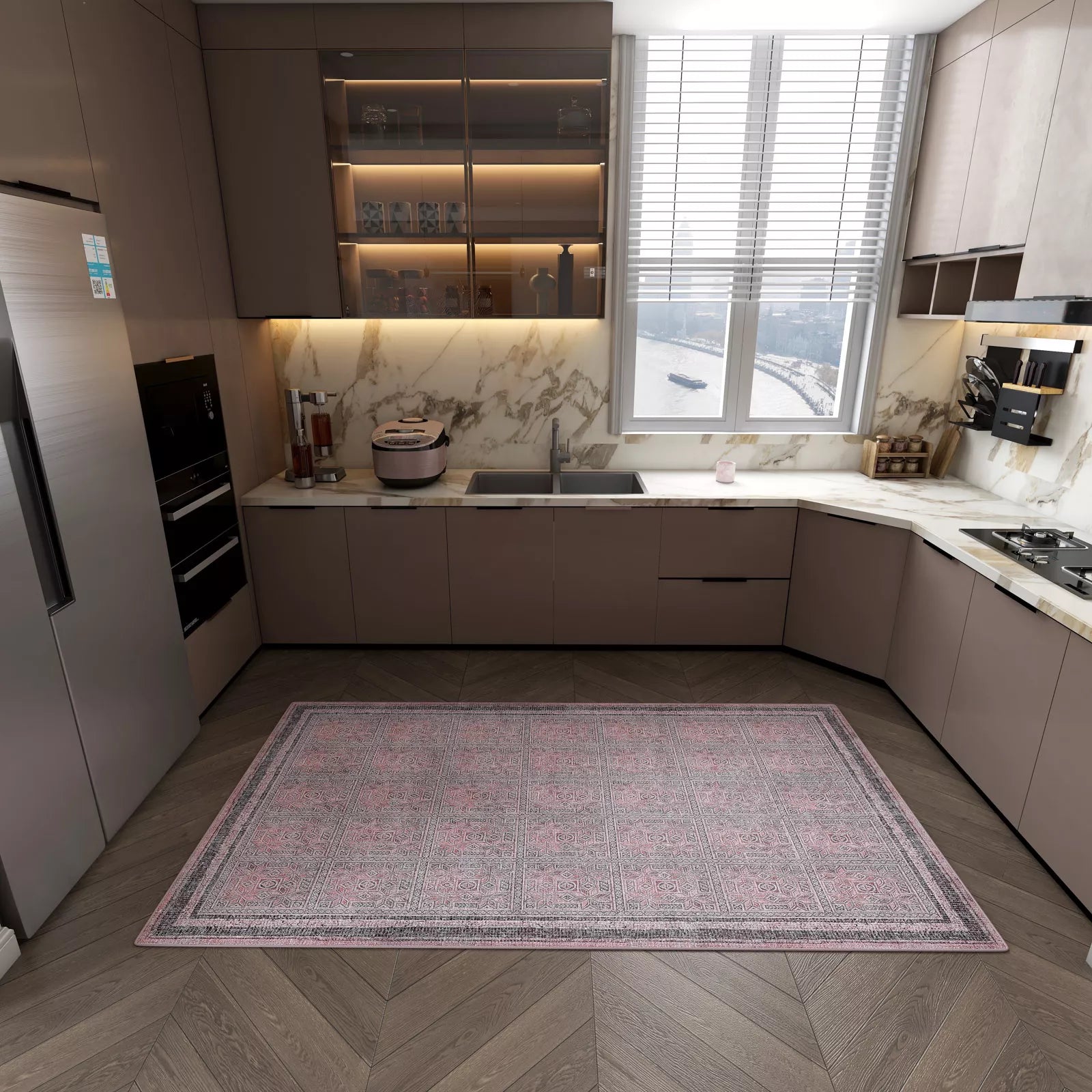 Modern kitchen with sleek brown cabinets, marble countertops, built-in appliances, and a large window with blinds. The wooden herringbone floor is decorated with the Rose Panel - Washable Rug - JRN1035 (Custom Size).