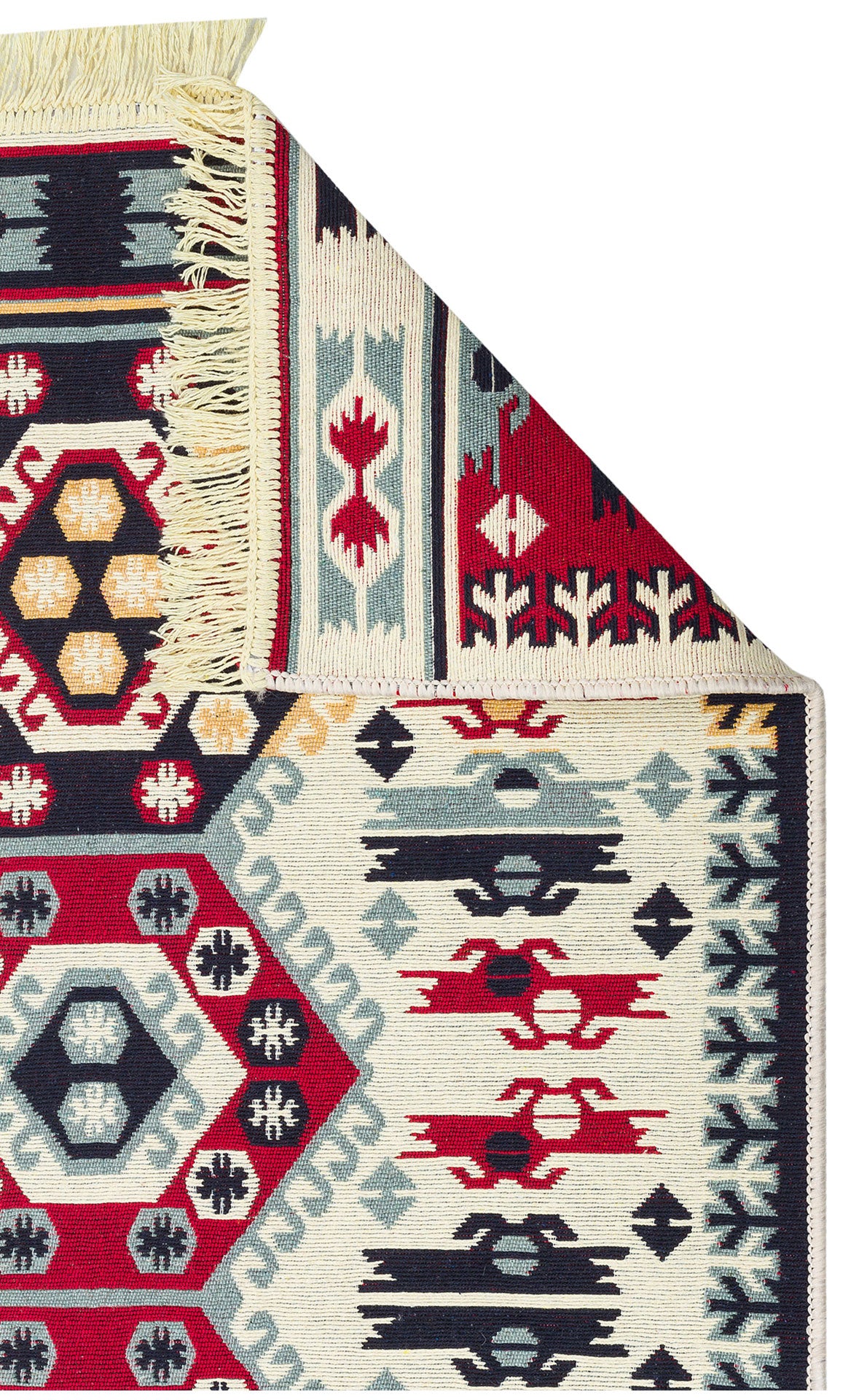 A close-up of the Ruby Weft - Washable Double-Sided Kilims - AR30 shows geometric and floral patterns in red, navy, yellow, and light blue. The folded corner reveals fringed edges and the reverse side's design.
