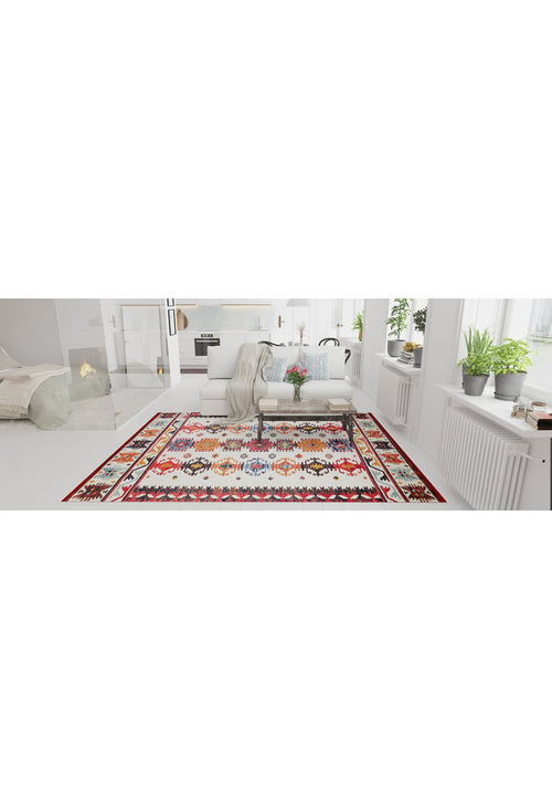 Load image 1 in gallery view. A bright living room with white walls and furniture, featuring the Rustic Refrain - Washable Rug - JR149 (Custom Size), a cushioned bench with a throw, potted plants on window sills, and a fireplace in the background.