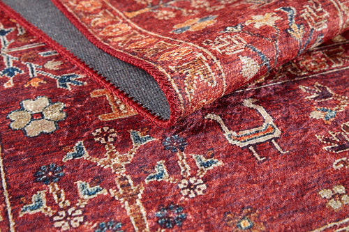 Load image 1 in gallery view. A close-up of the Rustic Retreat - Washable Rug - JR5095 (Custom Size) shows its red floral and geometric pattern, folded edge revealing a textured gray underside and stitched border—perfect for high-traffic areas.