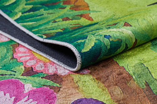 Load image 1 in gallery view. A close-up of the Safari Buddies - Machine-Washable Rug JRC041 (Custom Size), featuring a vibrant multicolor floral and leaf pattern, curled edge revealing black non-slip backing and detailed stitching—ideal for high-traffic areas.