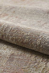 Close-up of the Sandy Whisper Neutral Rug - M628M, a high-end machine-made roll featuring a mottled pattern in beige, gray, reddish-brown, and gold. Its soft surface has a raised, slightly uneven texture.