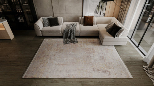 Load image 1 in gallery view. A modern living room with a light L-shaped sofa, brown and checkered cushions, a blanket, wood flooring, floor-to-ceiling windows with sheer curtains, and the Sandy Whisper Neutral Rug - M628M.