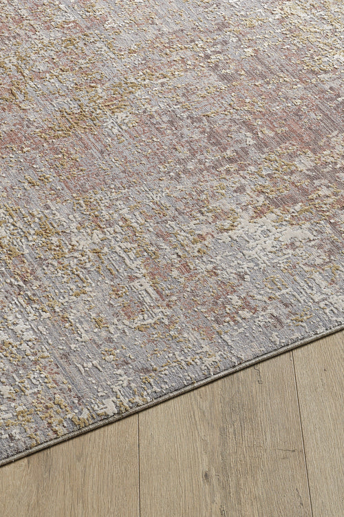 Load image 1 in gallery view. A close-up of the Sandy Whisper Neutral Rug - M628M, a machine-made rug featuring textured gray, taupe, and gold tones, displayed on a wooden floor.