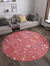 A modern living room with a gray sectional, yellow and dark pillows, wall shelves, and the Secret Garden - Washable Rug - JR1656 (Custom Size) in red leaf pattern—ideal for high-traffic areas on dark wood floors.