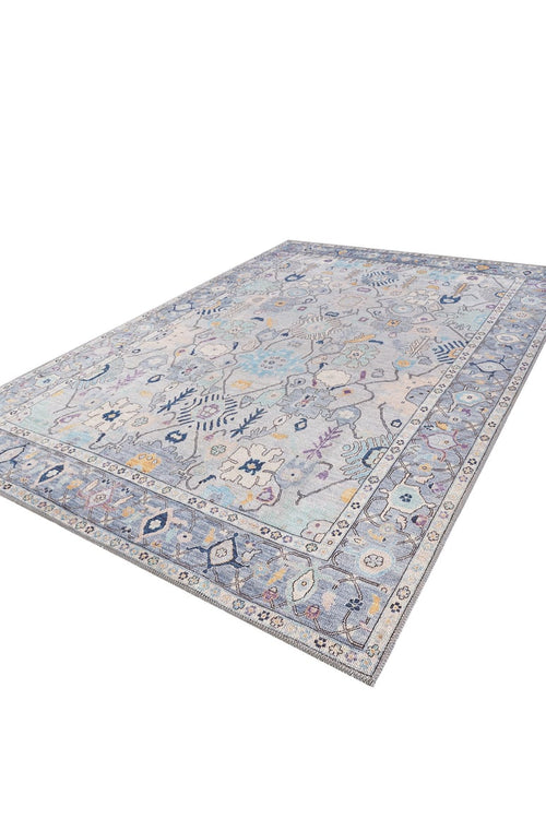 Load image 1 in gallery view. The Seraphix Pastel Bordered Washable Rug - LCC3011 features a large blue design with pale blue, gray, and cream background, intricate floral and geometric patterns in blue, yellow, and purple—ideal for high-traffic areas with a detailed matching border.