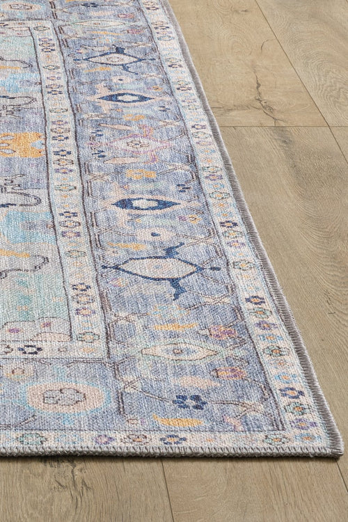 Bild 1 in Galerieansicht laden. A close-up of the Seraphix Pastel Bordered Washable Rug - LCC3011 (Custom Size) shows its rectangular blue design with geometric and floral patterns on a light wood floor—ideal for high-traffic areas.