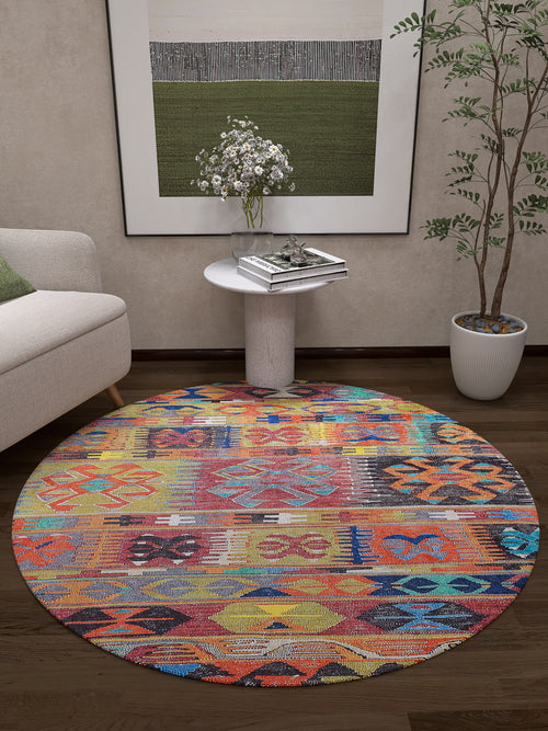 Load image 1 in gallery view. The Serene Sahara - Washable Rug - JR1959, with vibrant geometric patterns, adds color to a modern living room with dark wood floors. Ideal for high-traffic areas, it pairs well with a white sofa, side table, potted plant, and abstract wall art.