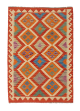 The Silk Road - Handwoven Kilim (Outlet) US is a square flatweave rug with a geometric diamond pattern in orange, red, blue, and green hues, bordered by cream and red zigzag designs.