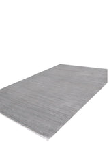 The Silver Lining Grey Rug - M352I is a large, rectangular flat pile rug in light gray with a subtle textured pattern, displayed on a white background.