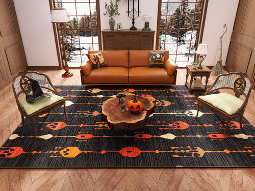 Load image 1 in gallery view. A cozy living room features a brown sofa, two armchairs, and a wooden coffee table with Halloween decor. The Skull Lanterns - Washable Rug - HLW005 with orange skulls adds a festive touch. Large windows reveal snowy trees outside.