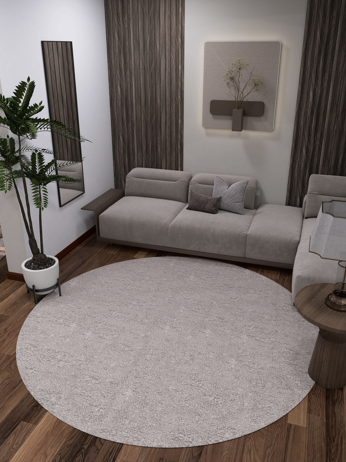 A modern living room with a gray sectional, dark wood floors, the Slate Charm - Washable Rug - JR1740 in cream and beige for high-traffic areas, a potted plant, wall mirror, minimalist art, and a dried floral wall arrangement.