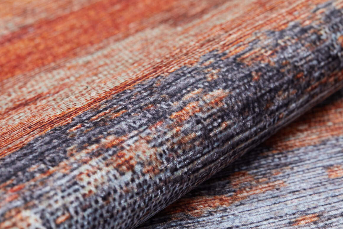 Close-up of the Sleek Brushed - Washable Rug - JR431 (Custom Size), featuring a textured abstract pattern in orange, brown, and gray—durable, stylish, and ideal for high-traffic areas with its fine woven horizontal details.