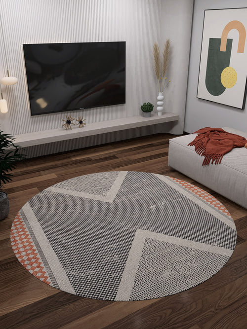 Load image 1 in gallery view. A modern living room featuring the Sleek Design - Washable Rug - JR1727 (Custom Size), allergy-friendly and flat weave, on wooden floors, with a wall-mounted TV, abstract art, a low bench with an orange throw, and minimalist decor with vases of dried and green plants.