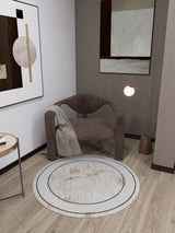 A cozy corner with a modern brown armchair, beige blanket, floor lamp, abstract wall art, and the Sleek and Contemporary - Washable Rug - JR1365—ideal for allergy-sensitive homes seeking minimalist style.