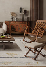 A modern living room features a beige sofa, wooden chairs, a low coffee table, and the Sleek and Contemporary - Washable Rug - JR1365 (Outlet) US in cream and beige hues, paired with an ornate red Asian-inspired sideboard.