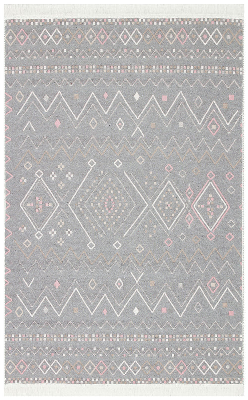 Load image 1 in gallery view. The Soft Bloom - Washable Reversible Kilims - AR05 is a rectangular rug with a grey background and geometric patterns in white, pink, and tan, featuring diamonds, zigzags, and dots in a symmetrical layout.