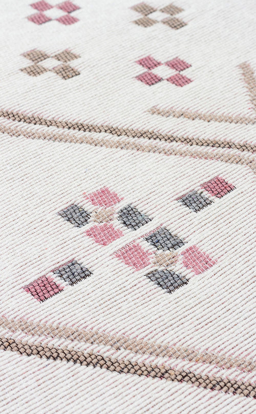 Load image 1 in gallery view. Close-up of the Soft Bloom - Washable Reversible Kilims - AR05 rug, showing its cream background with diamond and cross patterns in pink, brown, and gray. The detailed stitching and reversible texture are clearly visible.