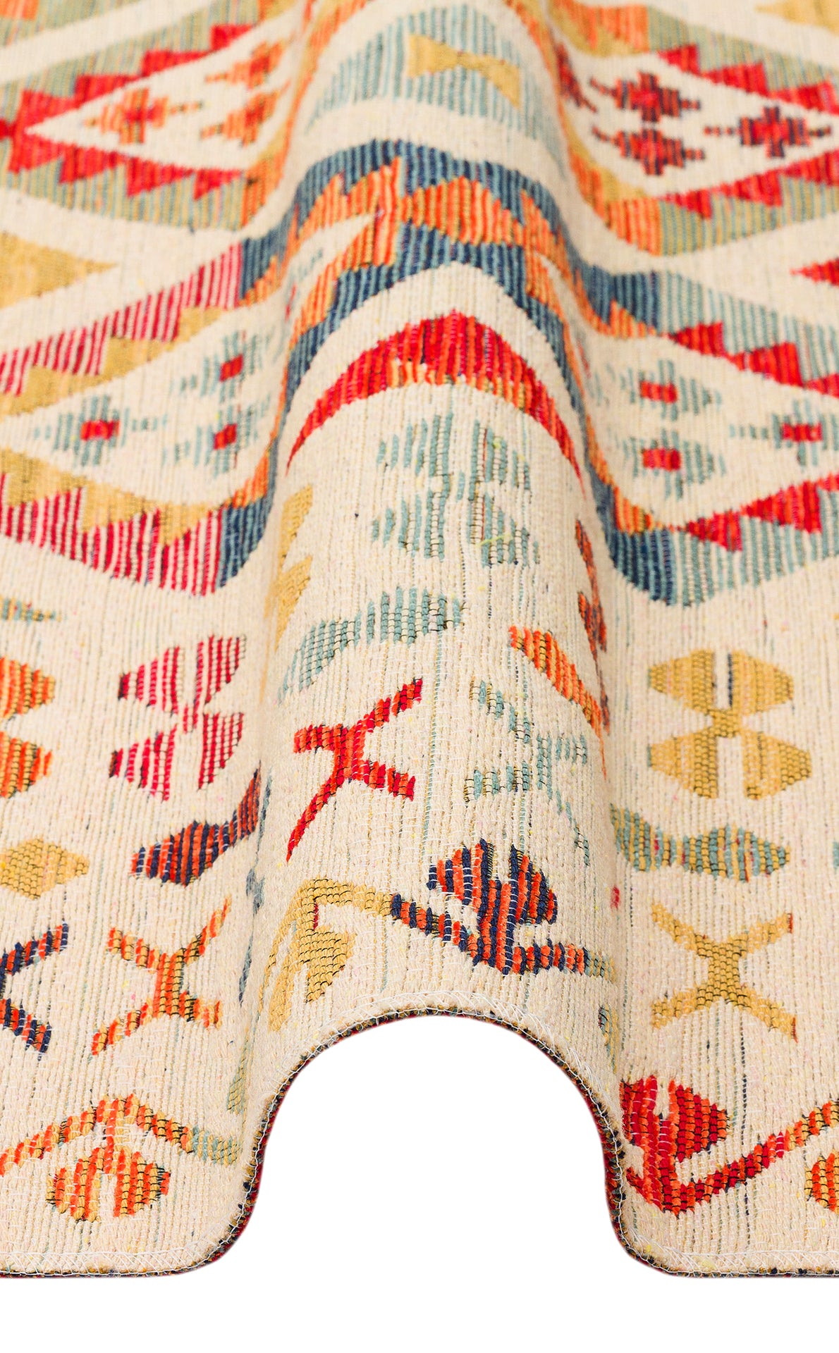 A close-up of the Soft Mosaic - Kilim - NMD08 rug, featuring red, blue, yellow, and green geometric patterns on a cream background. The draped display highlights its texture, thickness, and traditional motifs.