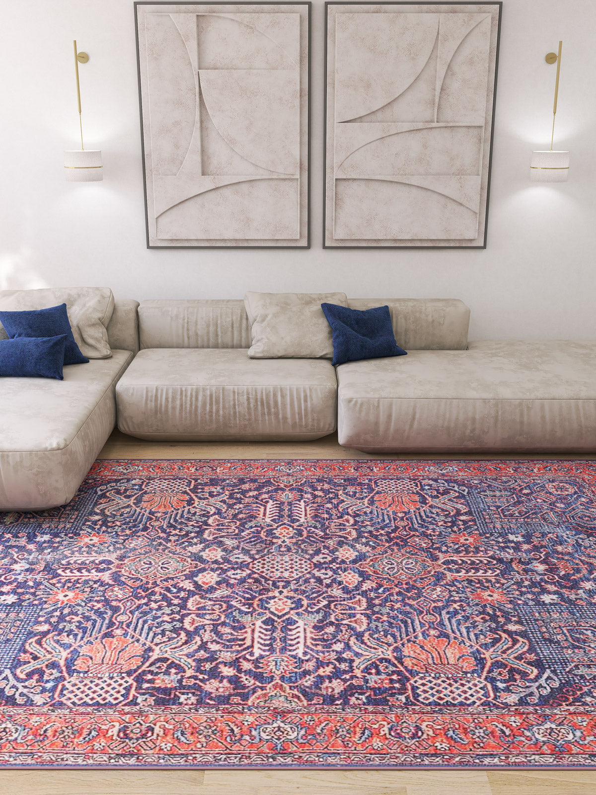 A modern living room with a beige sectional sofa, blue pillows, abstract wall art, and the Solstice Red Navy Washable Rug (LCC3026) in a custom size—its red and blue patterns are ideal for high-traffic wooden floors.