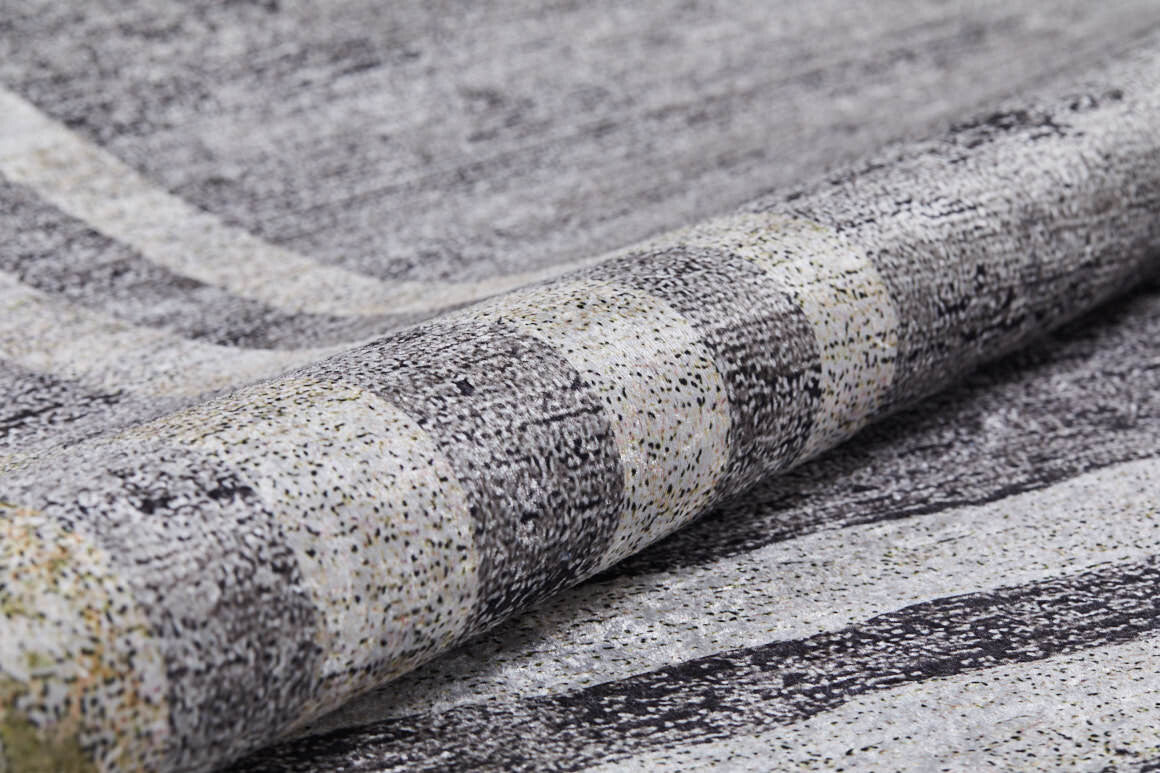 A close-up of the Sophisticated Trellis - Washable Rug - JR1194 (Custom Size), featuring a speckled, textured gray, black, and white pattern with subtle grid-like lines—ideal for high-traffic areas.