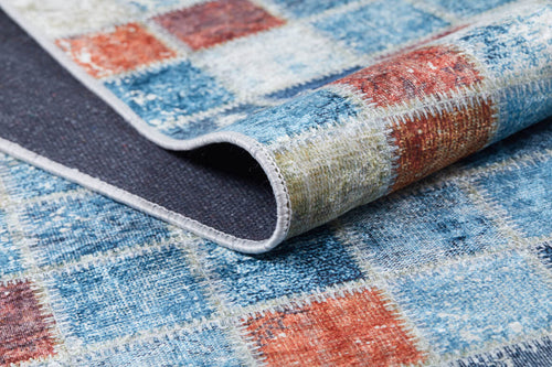 Load image 1 in gallery view. A close-up of the Square Serenity - Washable Rug - JR1255 (Custom Size) highlights its vibrant blue, red, and beige checkered pattern and durable stitching—ideal as a washable rug for high-traffic areas.