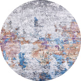 The Striking Statements - Washable Rug - JR786 features an oval, flat-weave design with abstract gray, blue, tan, and purple shades for a watercolor effect. Its textured look offers modern style plus easy maintenance.
