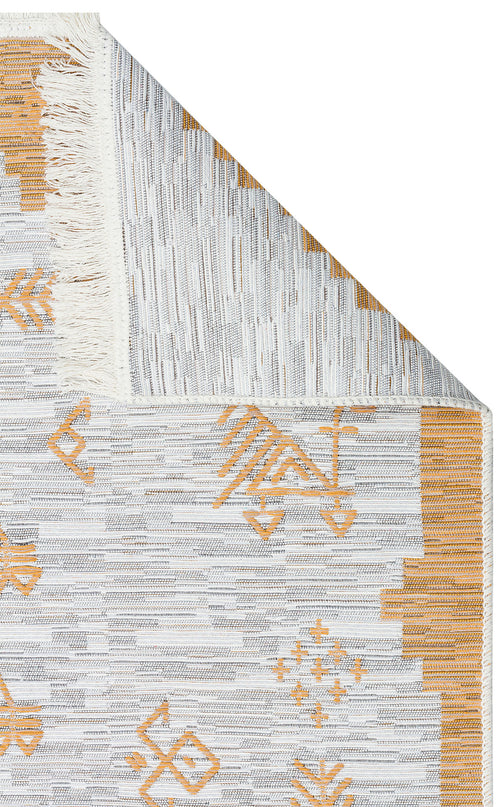 Load image 1 in gallery view. A close-up of the Sunbeam Line - Washable Double-Sided Kilims - AR23 shows a folded corner with white fringes, revealing both sides and a geometric pattern in light gray and mustard yellow.