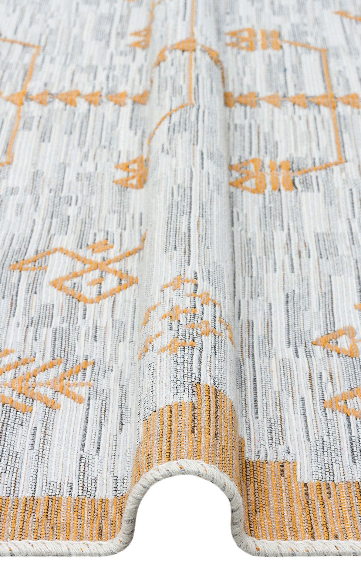 A close-up of the Sunbeam Line - Washable Double-Sided Kilims - AR23, a light gray and white recycled cotton rug with orange geometric patterns, shown with a gentle wave highlighting its bohemian texture and thickness.