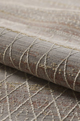 A close-up of the Sunkissed Boho Trellis Rug - M627M shows its machine-made gray base, white and beige geometric patterns, brown accents, and textured raised stitching, highlighting this modern neutral design.