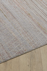 A close-up of the Sunkissed Boho Trellis Rug - M627M, featuring subtle white geometric lines and muted red accents, displayed on a light wooden floor.