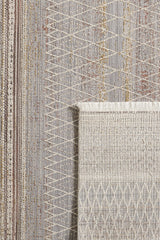 A close-up of the Sunkissed Boho Trellis Rug - M627M reveals its beige, gray, and muted yellow geometric diamond and linear patterns; one corner is flipped to show the textured underside of this machine-made neutral rug.