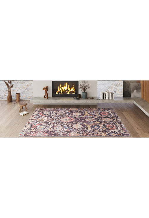 Bild 1 in Galerieansicht laden. A modern living room with a lit fireplace, decorative mantle objects, and the Sylvanor Colorful Washable Rug - LCC3017 in purple and gold tones—ideal for high-traffic areas—on a light wooden floor.