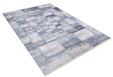 The Tartan Twist - Washable Rug - JR31 (Custom Size) features a rectangular, flat weave design in blue and gray patchwork with geometric textured blocks and stitched-style borders. Shown angled on a white background.