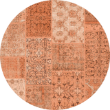 The Terracotta Patch - Washable Rug (JRN1037) is a round, flat weave rug in custom sizes, showcasing a patchwork design with orange and terracotta shades and detailed floral and geometric patterns in each section.