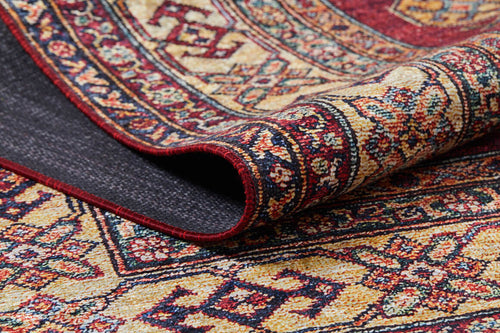 Load image 1 in gallery view. A close-up of the Time-Honored Textures - Washable Rug - JR40 (Custom Size) reveals red tones with geometric and floral designs in yellow, navy, and cream. Folded edge shows texture—perfect as a washable rug for high-traffic areas.