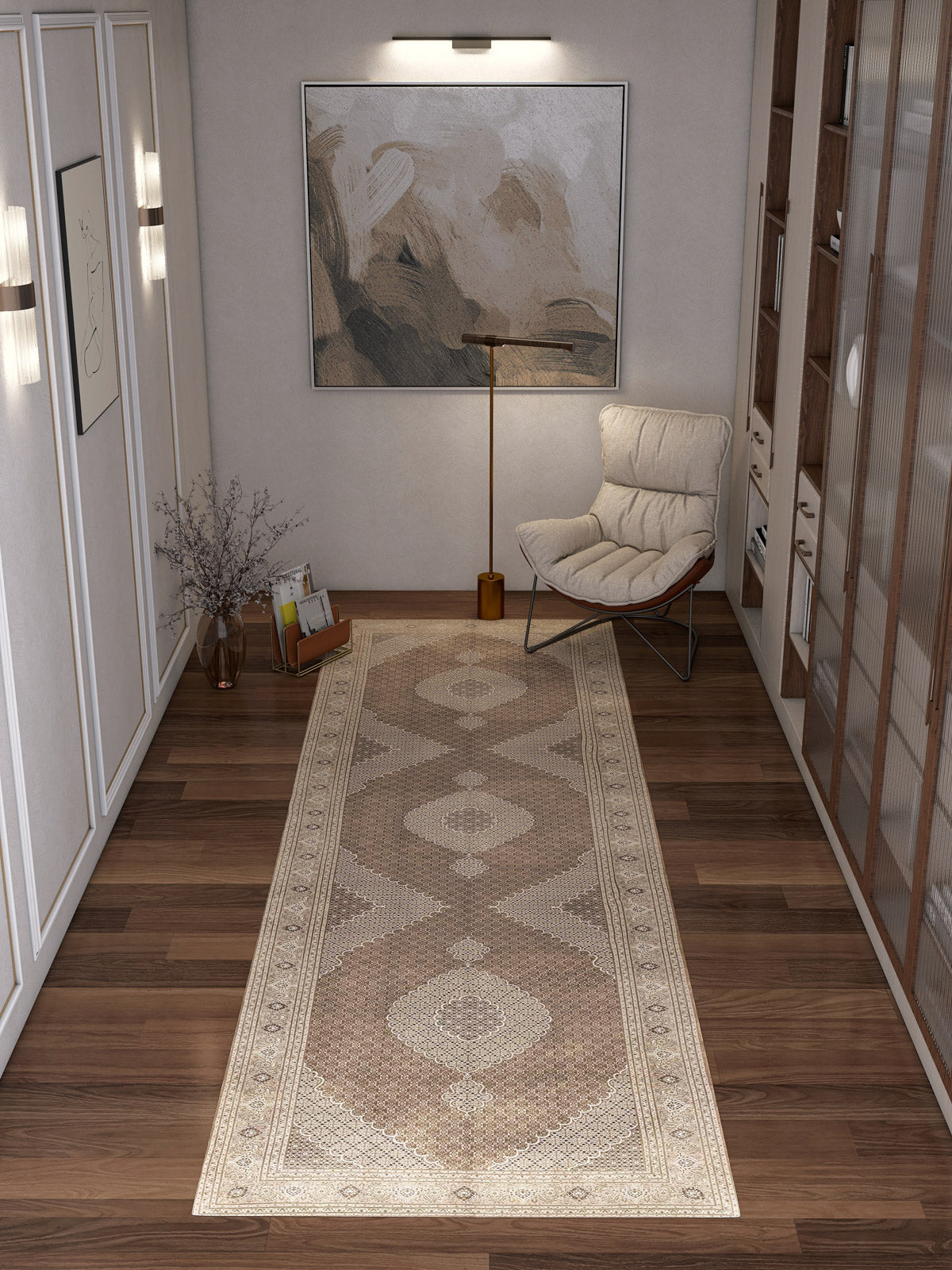A modern hallway with wooden floors, the Timeless Arabesque - Washable Rug - JRN1002 featuring a subtle medallion design, abstract wall art, a tall floor lamp, a cushioned chair, a glass vase with branches, and built-in shelves along one wall.