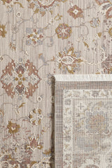 A close-up of the Timeless Petals Oushak Rug - Sand (M621N) shows its beige, brown, and muted gold floral patterns, with one corner flipped to reveal the fringe and backing.