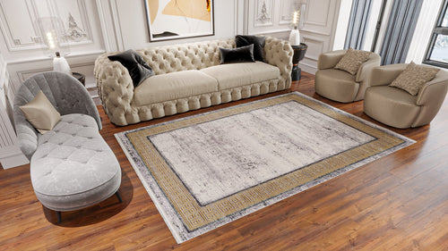 Load image 1 in gallery view. A modern living room features a beige tufted sofa, two round beige armchairs, a gray chaise lounge, and wooden floors. The Timeless Remix Bordered Rug - Beige - MT187 anchors the space, with art and molding detailing the light walls.