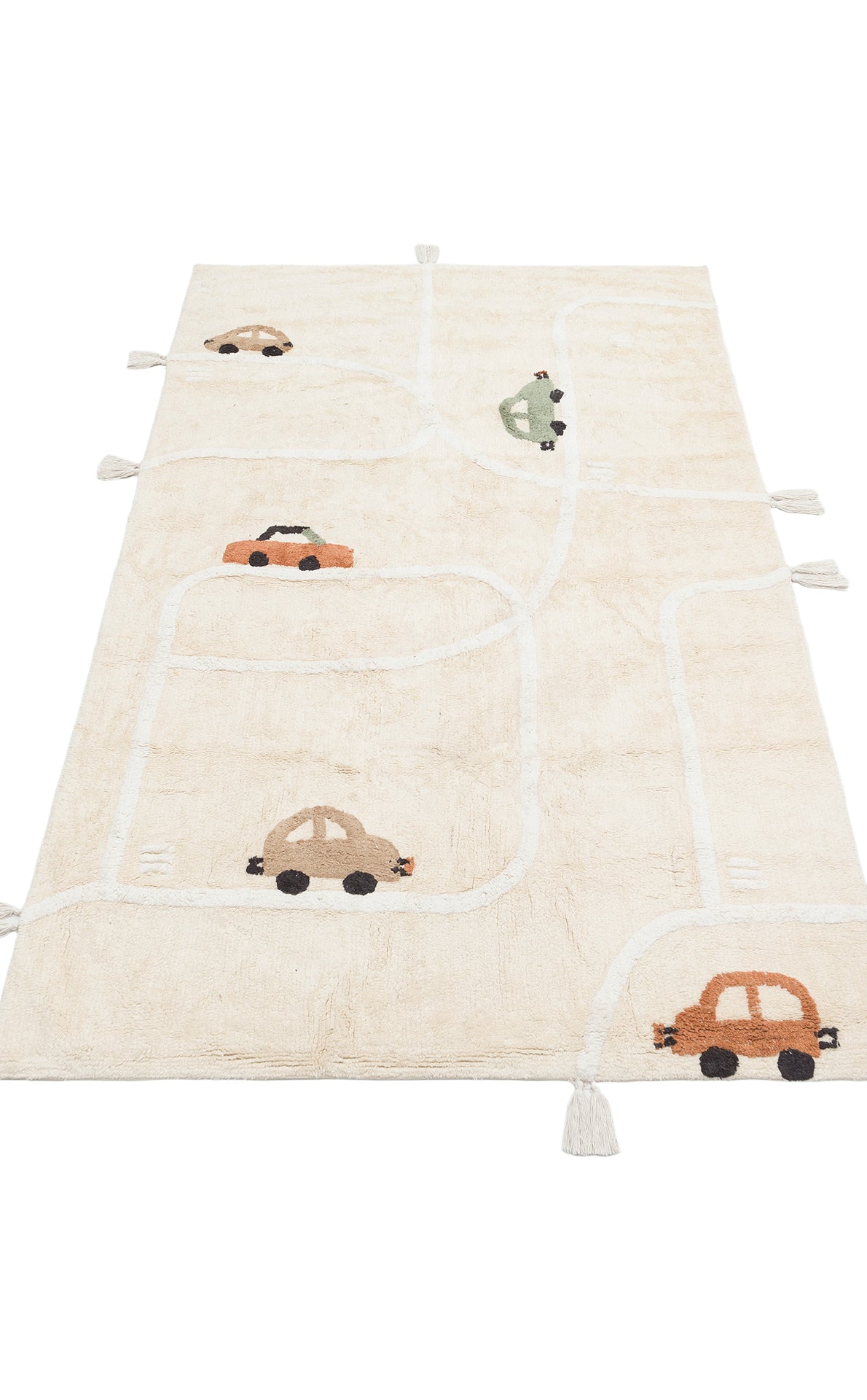 The Tiny Voyage - Washable Shaggy - CBN09 is a beige cotton kids rug with a winding white road, orange, green, and brown cartoon cars, and playful tassels on each corner—perfect for a fun playroom.